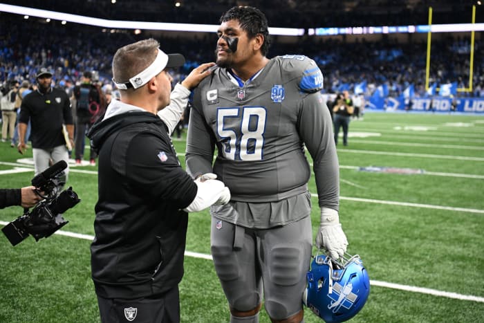 Oct 30, 2023; Detroit, Michigan, USA; Las Vegas Raiders head coach Josh McDaniels congratulates Detroit Lions offensive tackle Penei Sewell (58) after the Lions beat the Raiders in Monday Night Football at Ford Field.